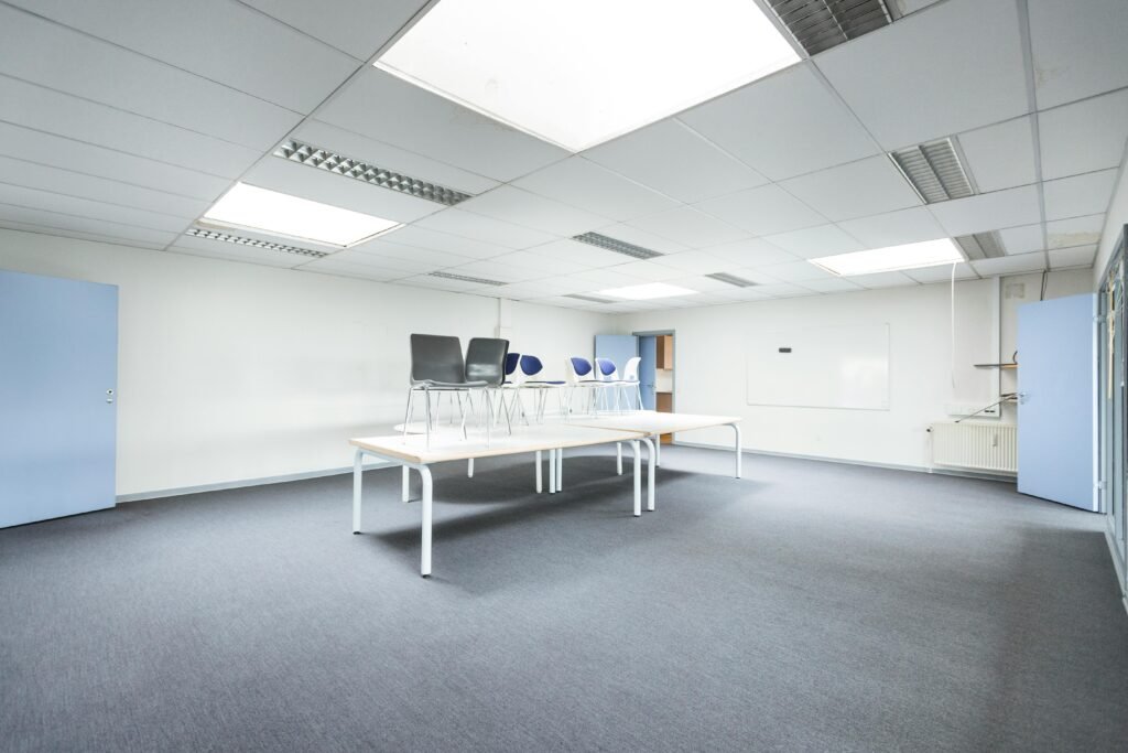 Spacious minimalist office with tables and chairs arranged creatively.