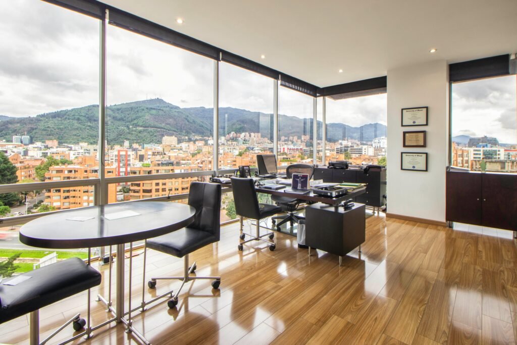 Spacious modern office with a scenic city view through glass windows.
